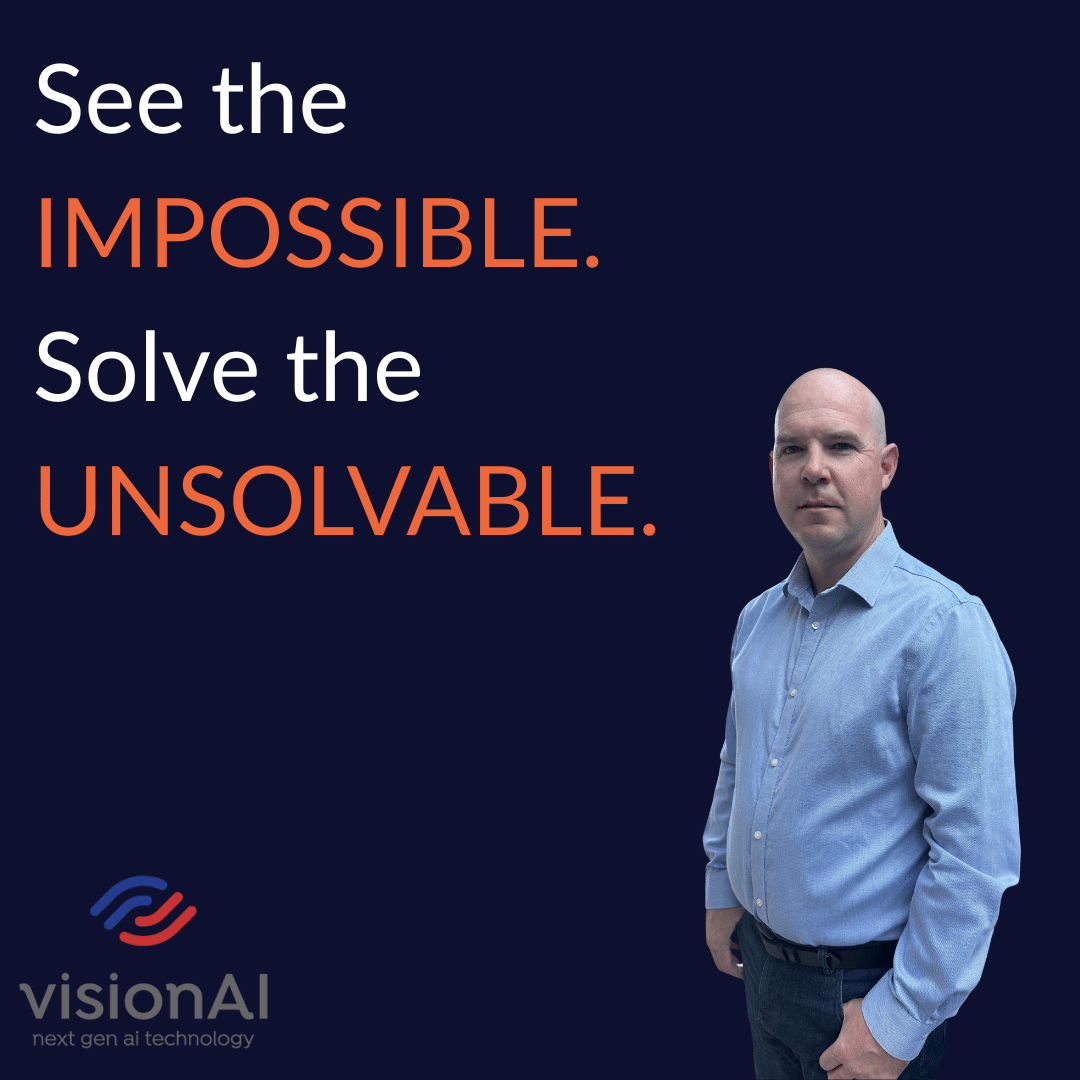 Man in a blue shirt standing beside bold text that reads “See the IMPOSSIBLE. Solve the UNSOLVABLE.” with the visionAI logo below.