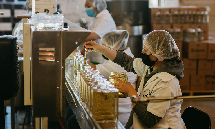 Workers assembling bottles on production line