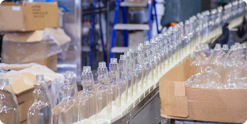 Empty glass bottles on production line